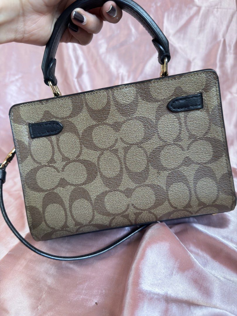 Coach Signature Canvas Top Handle Bag (Category: Luxury Bags & Wallets) located in Manila. Submitted by olxph_ (Listing ID 1449367088, Image 2). Description: Original coach mini lane top handle Like new Pm me .