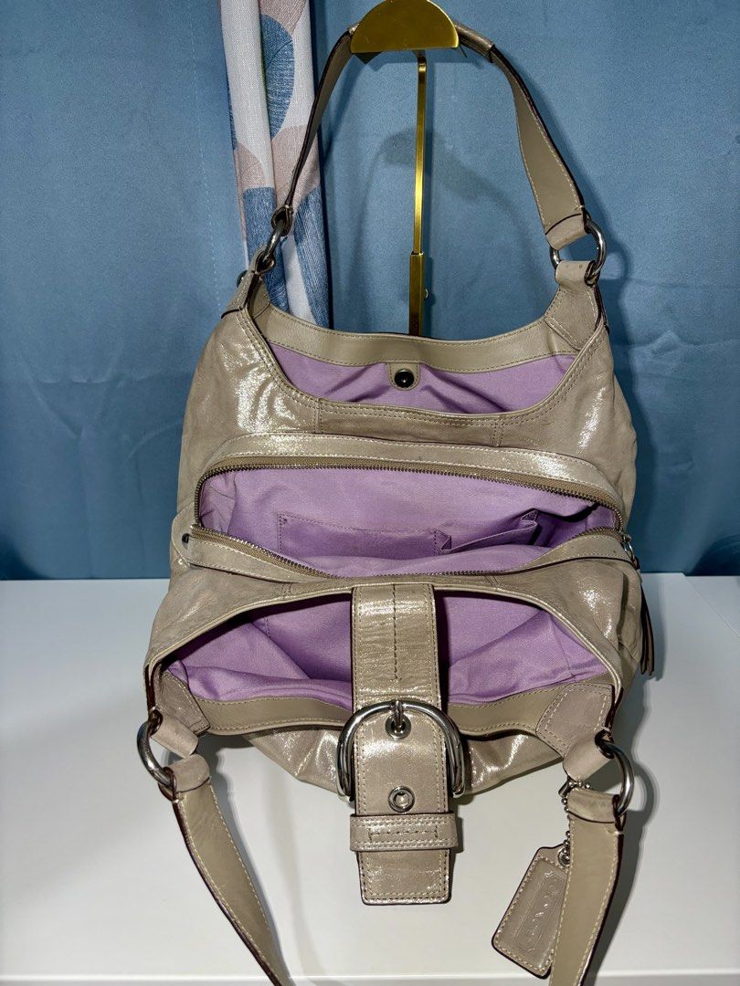 Coach Soho Lynn Hobo Shoulder Bag (Category: Shoulder Bags) located in Pasig City. Submitted by talaversify (Listing ID 1449497486, Image 3). Description: • Authentic Coach Soho Lynn in hobo shoulder shape featuring pleated front accents and a prominent decorative center buckle flap with a magnetic snap closure. • Shimmery, metallic champagne gold cowhide leather in silver-tone hardware. • Multi-compartment interior consisting three main sections