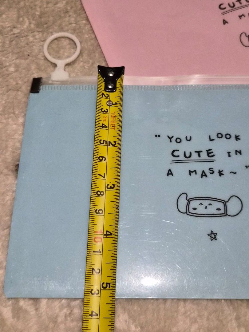 Cute Mask Design Zipper Pouch - Blue 2 pcs (Category: Purses & Pouches) located in Mandaue City. Submitted by chuchi152615 (Listing ID 1449512260, Image 3). Description: - Light blue zipper pouch - Features a cute mask drawing and 'YOU LOOK CUTE IN A MASK~' text - Zipper works well with a white ring pull - Ideal for storing small items (stationery, makeup, etc.) - Approximately 9 inches wide.
