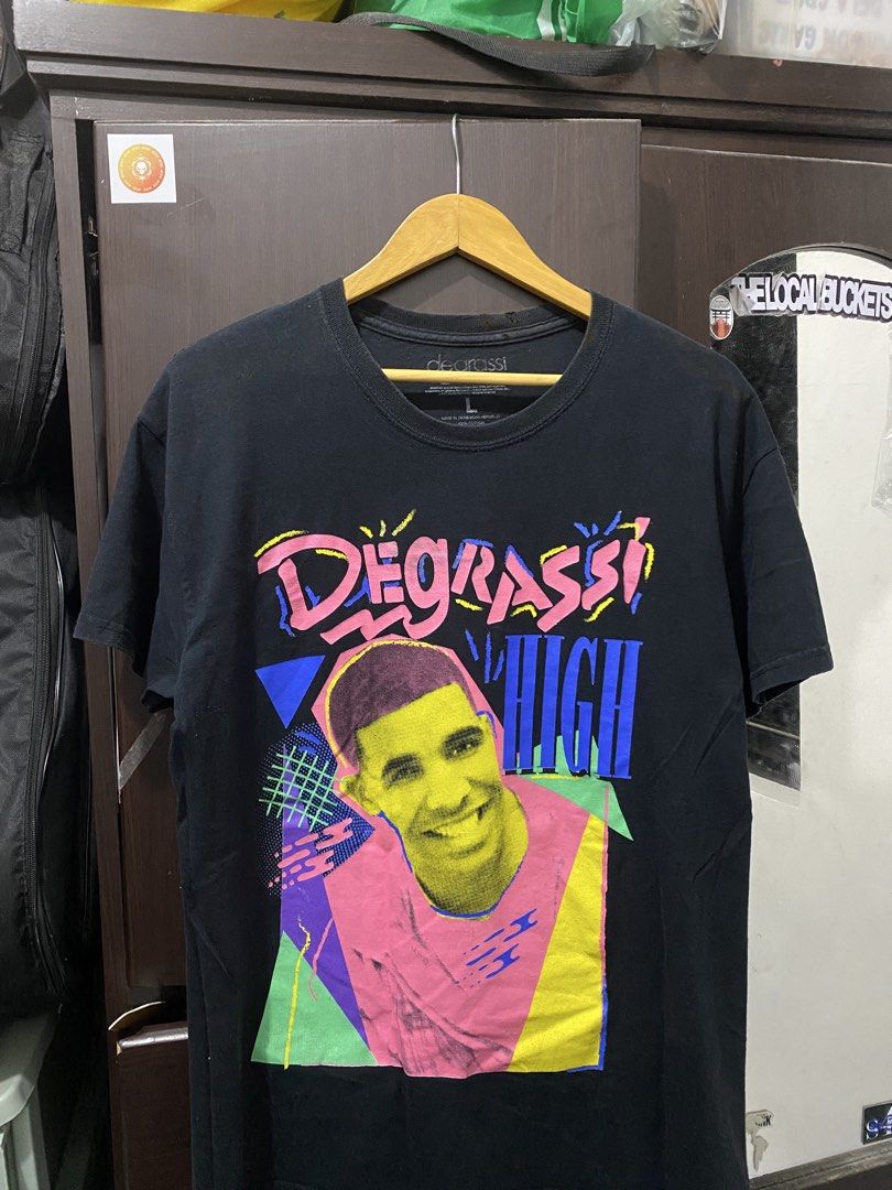 Degrassi High Drake T-shirt (Category: Tshirts & Polo Shirts ) located in Cavite. Submitted by grabanddeclutter (Listing ID 1449333348, Image 1). Description: - In great condition, check issues last 3 pictures - Black t-shirt with Drake 'Degrassi High' graphic print - Retro, colorful design - Dimensions: Width 21 Length 28 No COD gcash payment Plus shipping fee Jnt or lalamove.