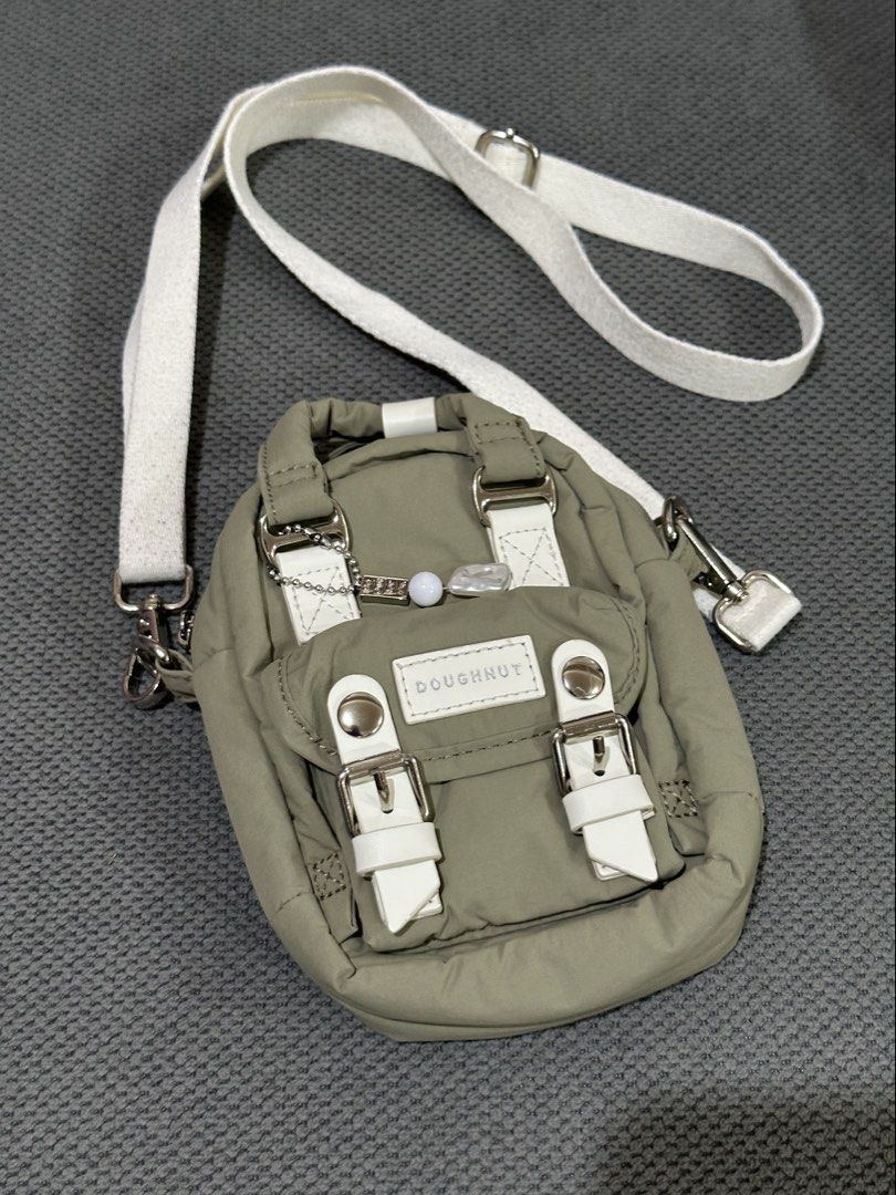 Doughnut Macaroon Tiny Beyond The Horizon Bag - Army (Category: Backpacks) located in Manila. Submitted by declutterbyja (Listing ID 1449358390, Image 1). Description: - Doughnut Macaroon Tiny Beyond The Horizon Series - Color: Army - Purchased from Doughnut Philippines - Original Price: P3,495.00 - Small and compact, ideal for carrying essentials - Features a main compartment and a front pocket - Adjustable strap for comfortable wear - Main pock
