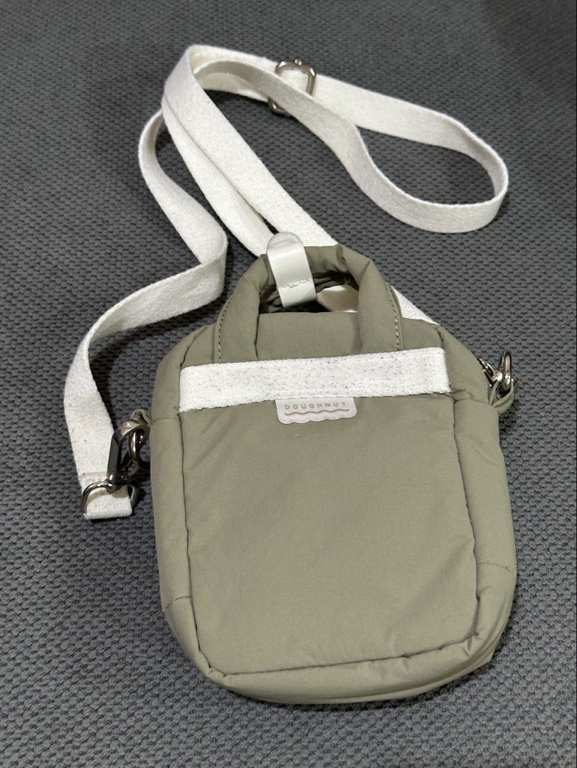Doughnut Macaroon Tiny Beyond The Horizon Bag - Army (Category: Backpacks) located in Manila. Submitted by declutterbyja (Listing ID 1449358390, Image 2). Description: - Doughnut Macaroon Tiny Beyond The Horizon Series - Color: Army - Purchased from Doughnut Philippines - Original Price: P3,495.00 - Small and compact, ideal for carrying essentials - Features a main compartment and a front pocket - Adjustable strap for comfortable wear - Main pock