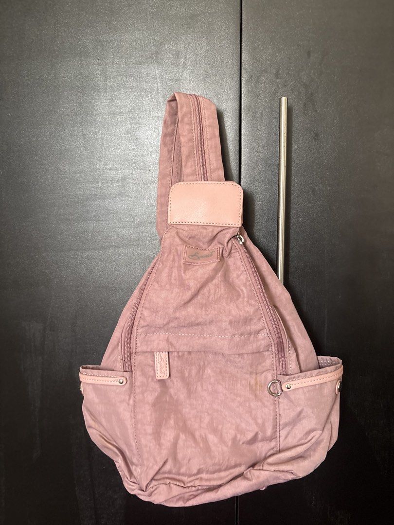 Dusty Rose Convertible Sling Backpack (Category: Luxury Bags & Wallets) located in Quezon City. Submitted by honeys_resells (Listing ID 1449351777, Image 1). Description: ✨ Excellent condition – no tears, holes, or broken zippers; only minimal signs of use ✨ Soft dusty rose nylon backpack with faux leather accents for a chic everyday look ✨ Convertible design lets you wear it as a backpack or sling bag ✨ Multiple zippered compartments and side po
