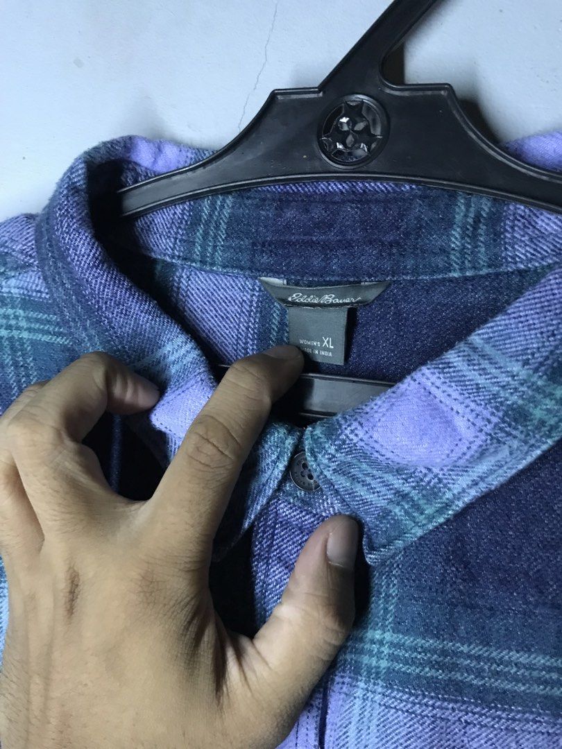 Eddie Bauer Flannel Size XL (Category: Tshirts & Polo Shirts ) located in Mabalacat. Submitted by jayty_ (Listing ID 1449446900, Image 2). Description: - Eddie Bauer Flannel Shirt - Size: XL - Color: Classic Purple & Green Plaid - Style: Long sleeves with button cuffs - Features: One chest pocket - Material: Comfortable and warm, perfect for layering or standalone wear.