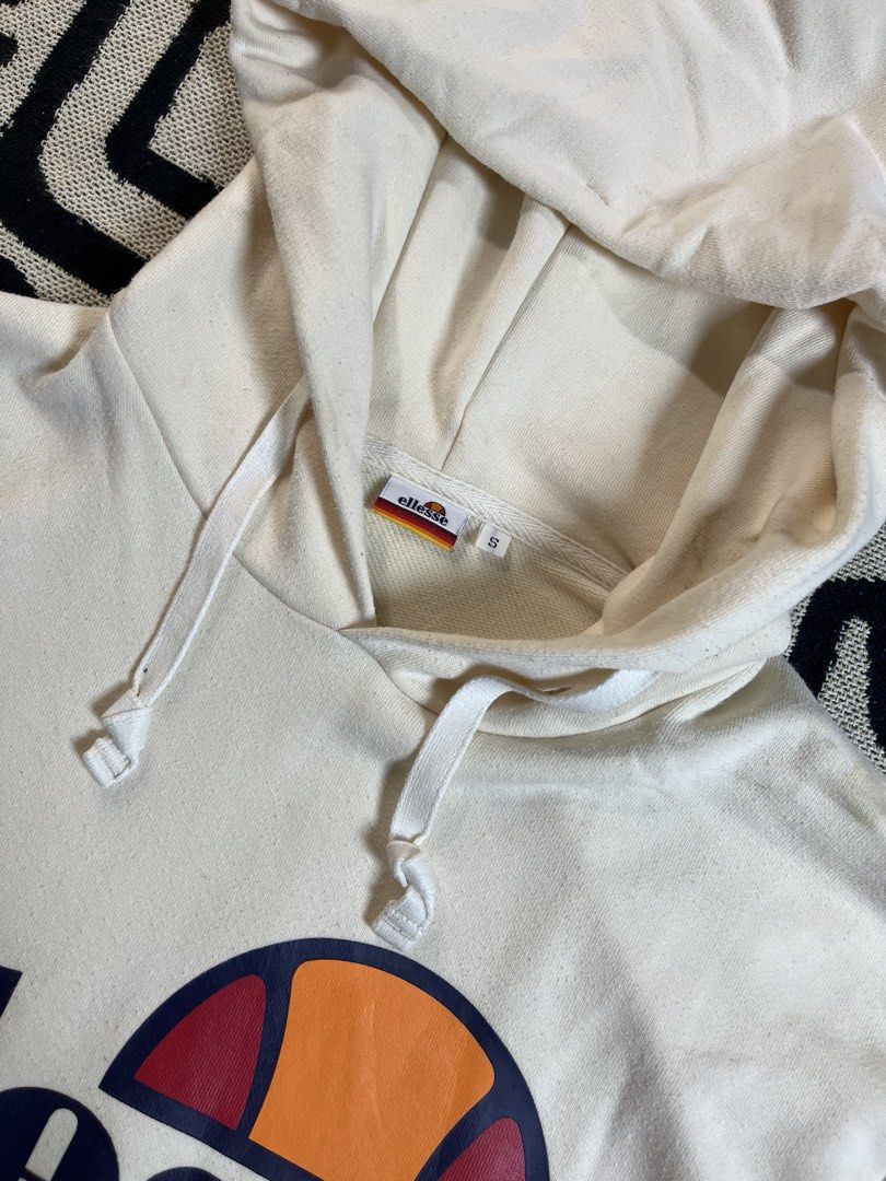 Ellesse Cream Hoodie with Logo (Category: Hoodies) located in Silang. Submitted by yusthrift (Listing ID 1449343655, Image 3). Description: - Cream coloured Ellesse hoodie - Classic Ellesse logo on the front - Convenient kangaroo pocket - Adjustable drawstring hood - Size S on tag (M-L women) - Ideal for everyday casual wear 21 inches width 25.5 inches length No issue Very good condition Need wash.