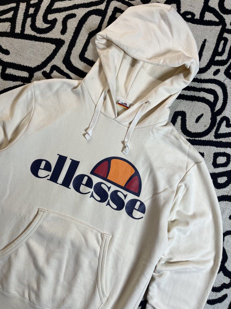 Ellesse Cream Hoodie with Logo (Category: Hoodies) located in Silang. Submitted by yusthrift (Listing ID 1449343655, Image 2). Description: - Cream coloured Ellesse hoodie - Classic Ellesse logo on the front - Convenient kangaroo pocket - Adjustable drawstring hood - Size S on tag (M-L women) - Ideal for everyday casual wear 21 inches width 25.5 inches length No issue Very good condition Need wash.