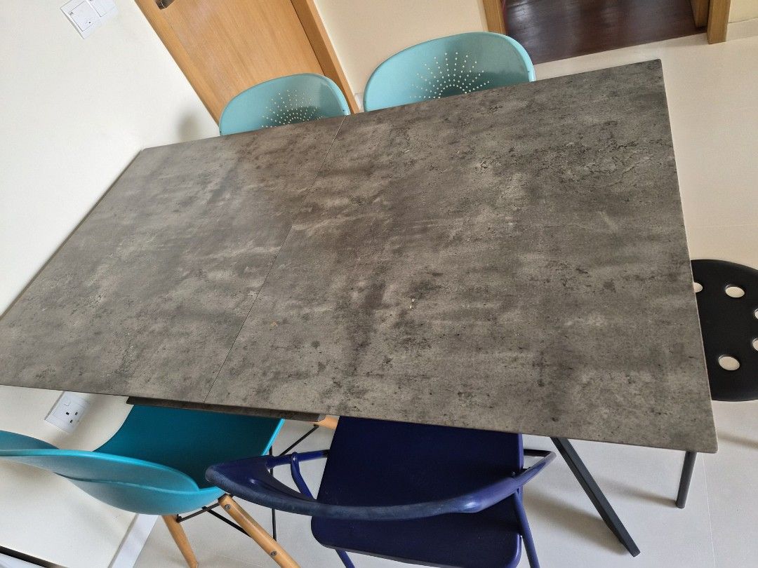 Extendable Dining Table (Category: Tables & Sets) located in Singapore. Submitted by windy80 (Listing ID 1449327968, Image 1). Description: - 1.4m extenable Dining table with stylish concrete-look top, some peeling off (not for fussy) - Sturdy black metal table legs - can take the 3 green chairs if you want, some parts rusty - collect on 1 or 2 Aug, arrange own delivery.