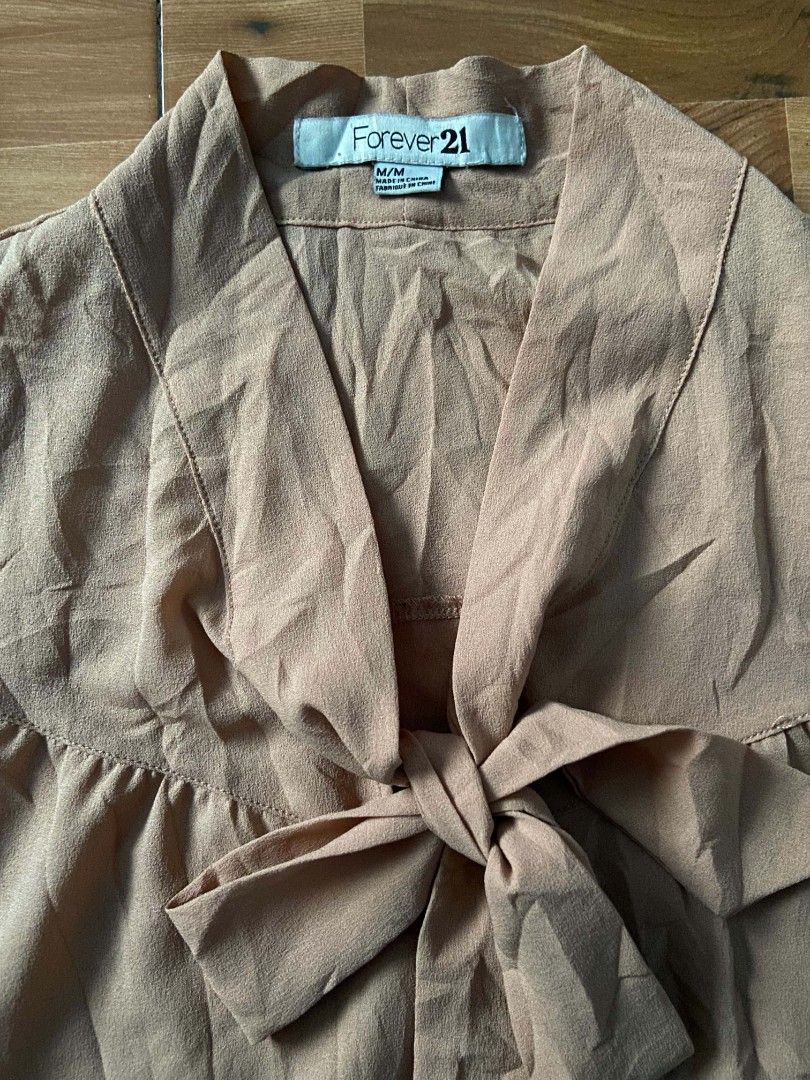 Forever 21 Peach Bow Neck Blouse M/M (Category: Blouses) located in Nabua. Submitted by chic-rack (Listing ID 1449402459, Image 3). Description: - Forever 21 Peach Blouse - Size: Medium (M) - Adorable bow detail at the neckline - Full-length sleeves with elastic cuffs - Lightweight and comfortable material - Versatile for both casual and dressy occasions -Price+SF.