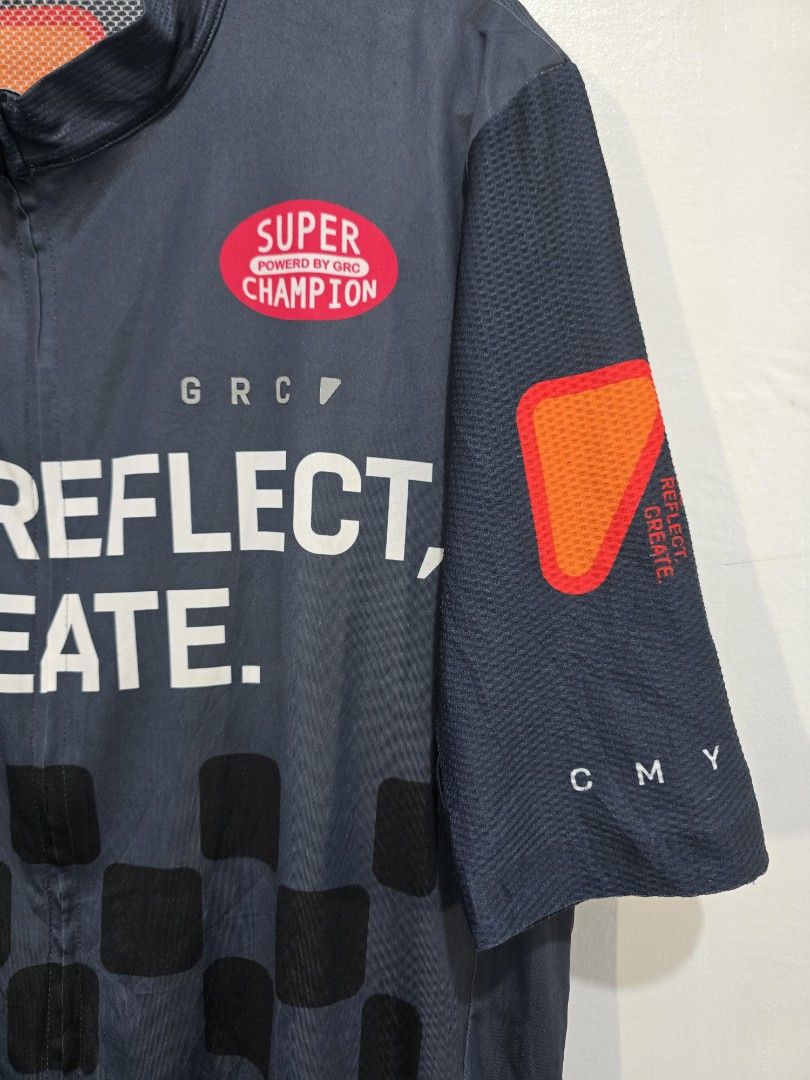 GRC Cycling Jersey (Category: Activewear) located in Abuyog. Submitted by rmrtabs (Listing ID 1449444459, Image 3). Description: - Dark grey cycling jersey - Bold white text: 'GROW, REFLECT, CREATE.' - Checkered pattern detail - 'SUPER CHAMPION' and 'POLARTEC' branding - Breathable mesh panels on sleeves and sides - Three convenient back pockets - Ideal for cycling enthusiasts The size is XXXL but fits like XL. Color may vary due to lighting. Ite