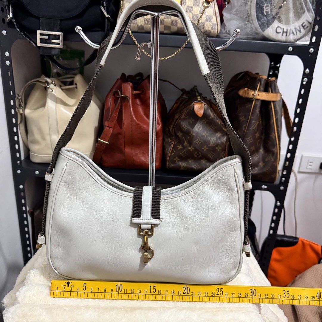 Gucci Jackie Canvas Leather Gray Shoulder Bag (Category: Luxury Bags & Wallets) located in Manila. Submitted by retro.archives (Listing ID 1449497987, Image 3). Description: Gucci Jackie Canvas Leather Gray Shoulder Bag Condition & Flaws: (See Detailed Pictures Attached) Made in Italy 📐 Measurements in CM Height: 18 cm Width: 27 cm Depth: 5.5 cm Drop: 25 cm Code: 92736 203998 📎 TAKE NOTE : • Please note that this is a used / thrifted piece, and