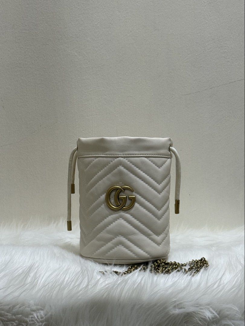 Mini Gucci GG Marmont Matelassé Bucket Bag (Off-White) (Category: Cross-body Bags) located in Quezon City. Submitted by clazzystudio (Listing ID 1447658799, Image 1). Description: Selling this chic Gucci GG Marmont Matelassé Bucket Bag in classic off-white quilted leather, featuring signature antique gold-tone Double G hardware and chain strap! ✨ Features & Details: Material: Matelassé chevron leather with antique gold-tone hardware Color: Off-Wh