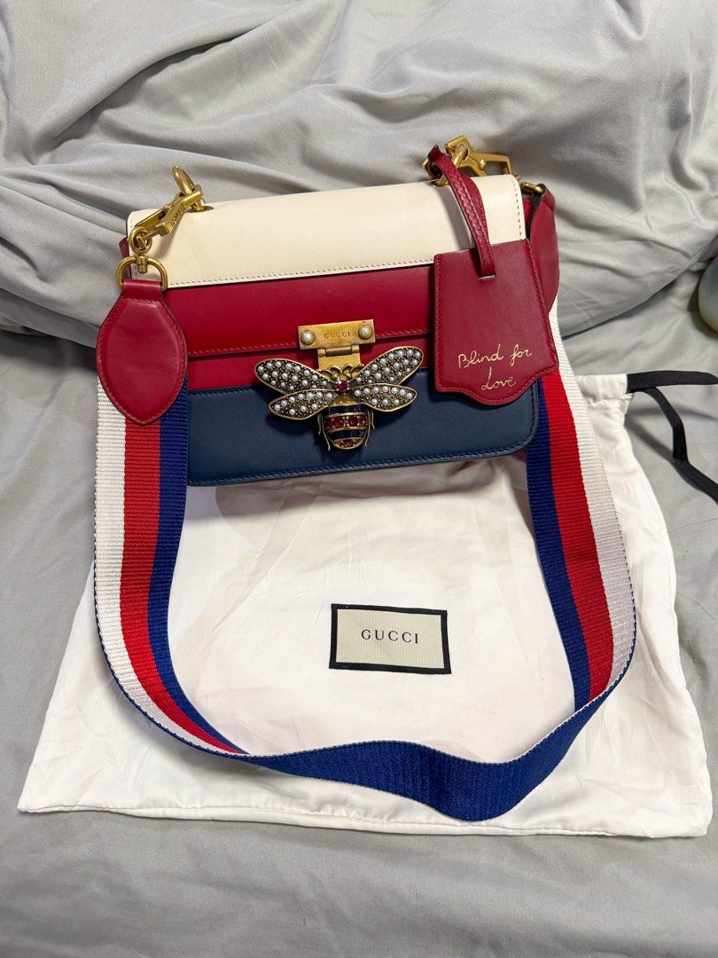 Gucci Queen Margaret Bee Shoulder Bag (Category: Luxury Bags & Wallets) located in Manila. Submitted by tinseyra (Listing ID 1449368473, Image 1). Description: - Authentic Gucci Queen Margaret Bag - Iconic bee embellishment with pearl and crystal details - Signature Gucci red, white, and blue stripe strap - 'Blind for Love' tag detail - Comes with original dust bag - Perfect statement piece for any outfit.