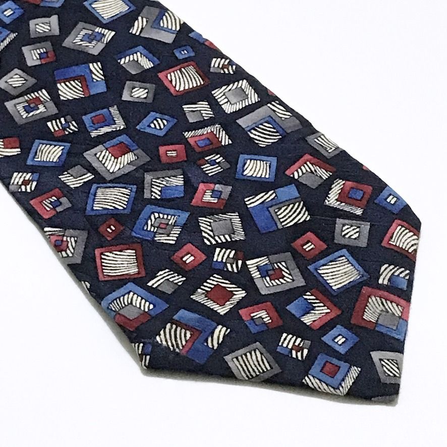 Guy Laroche Monsieur Deep Navy Geometric Pattern Neck Tie (Category: Ties) located in Taguig. Submitted by retrogaze (Listing ID 1449529662, Image 2). Description: This striking vintage necktie by French luxury fashion house Guy Laroche is made from premium 100% silk. It showcases a rich, deep navy blue base adorned with an eye-catching abstract geometric pattern of nesting squares. Featuring bold accents of royal blue, muted red, gray, and zebra