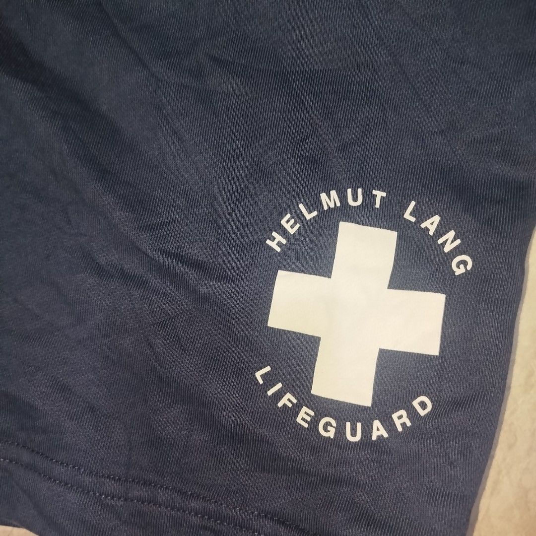 Helmut Lang Lifeguard Shorts Navy Blue (Category: Shorts) located in Davao. Submitted by vernoneighty4 (Listing ID 1449478297, Image 3). Description: - Navy blue Helmut Lang shorts - Features 'Lifeguard' graphic print on the leg - dimension W32-38 L21 - Elastic waistband with drawstring - Comfortable fit - Perfect for casual wear.