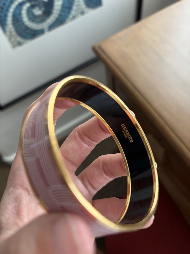Hermes Enamel Bangle Bracelet (Category: Bracelets) located in Manila. Submitted by migflo (Listing ID 1449379934, Image 2). Description: - Authentic Hermes bangle - Iconic H pattern in red and white - Black enamel interior with gold trim - Classic and elegant accessory - Circumference: 7 inches.