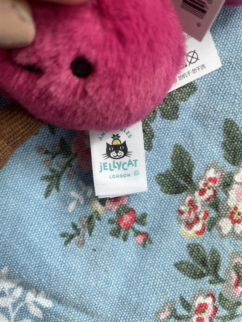 Jellycat Amuseables Cherries Bag Charm Keychain (Category: Plushies & Soft Toys) located in San Juan City. Submitted by nicheprincess (Listing ID 1449385562, Image 3). Description: - Super cute Jellycat Amuseables Cherries bag charm - Features two fluffy pink cherries with adorable faces - Includes brown stems - Comes with a metal keyring and clip for easy attachment - Perfect for adding a fun, playful touch to your bag or backpack - Brand new wi