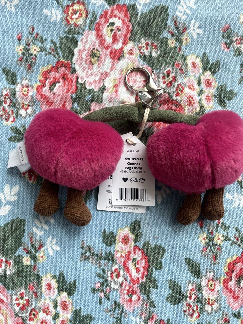 Jellycat Amuseables Cherries Bag Charm Keychain (Category: Plushies & Soft Toys) located in San Juan City. Submitted by nicheprincess (Listing ID 1449385562, Image 2). Description: - Super cute Jellycat Amuseables Cherries bag charm - Features two fluffy pink cherries with adorable faces - Includes brown stems - Comes with a metal keyring and clip for easy attachment - Perfect for adding a fun, playful touch to your bag or backpack - Brand new wi
