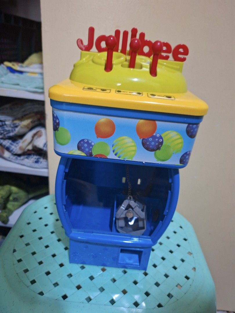 Jollibee Toy Vending Machine (Category: Kids Toys) located in Paranaque City. Submitted by tsentiatsen (Listing ID 1449356953, Image 1). Description: - Jollibee toy vending machine - Bright yellow and blue colors - Fun design with colorful balloons - Perfect for kids who love Jollibee - Features games and toy dispensing.