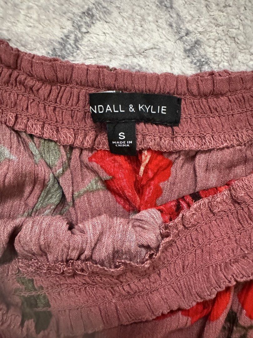 Kendall & Kylie Off-Shoulder Floral Romper (Category: Rompers) located in Manila. Submitted by chaz16 (Listing ID 1449380666, Image 2). Description: - Cute off-shoulder romper - Floral print - Long sleeves - Smocked neckline and waist - Tie detail at waist - Cinched waist - Ideal for casual wear or beach trips Bought in the US NEVER WORN.