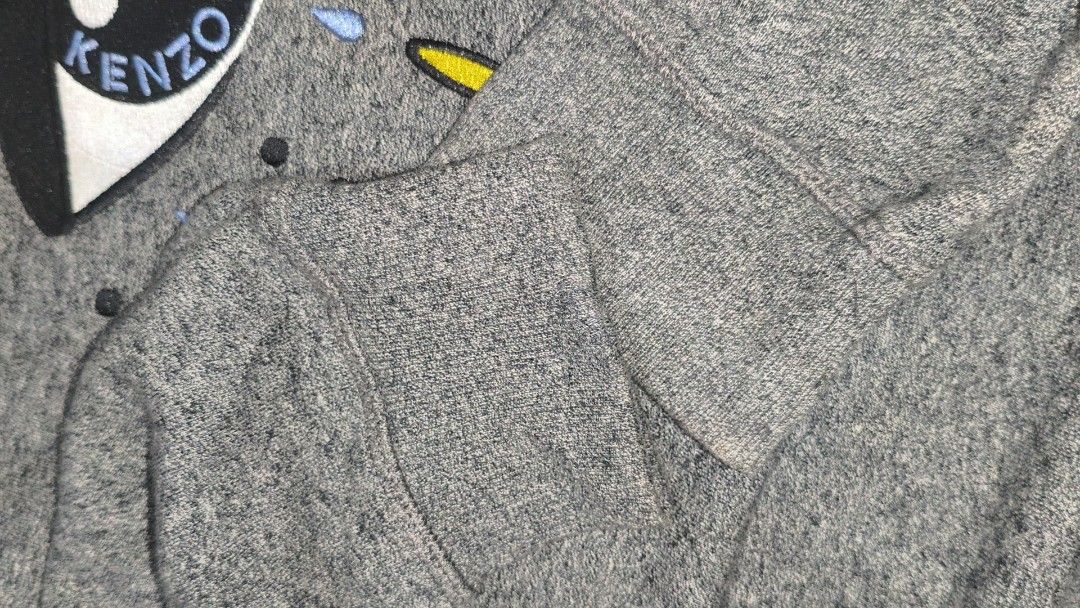 Kenzo Paris Eye Logo Grey Sweatshirt (Category: Coats, Jackets and Outerwear) located in San Francisco. Submitted by prince0922 (Listing ID 1449395599, Image 3). Description: - Grey Kenzo sweatshirt - Features the iconic eye logo - Made in Portugal - Crew neck, long sleeves - Comfortable and stylish for casual wear - Check out the print details! - Brand New condition if not for the minimal issue, check the last picture!.