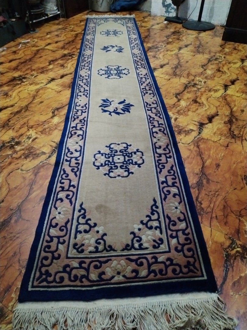 Long Oriental Runner Rug with Blue and Beige Pattern (Category: Carpets, Mats & Flooring) located in Caloocan City. Submitted by rowely_jpn (Listing ID 1449437021, Image 1). Description: Selling a long runner rug. Features a beige base with blue and pink floral patterns. Has a dark blue border and fringed ends. Great for hallways or entryways. Measures approximately 140 inches long. Good condition, some minor marks visible.japan surplus po ito..