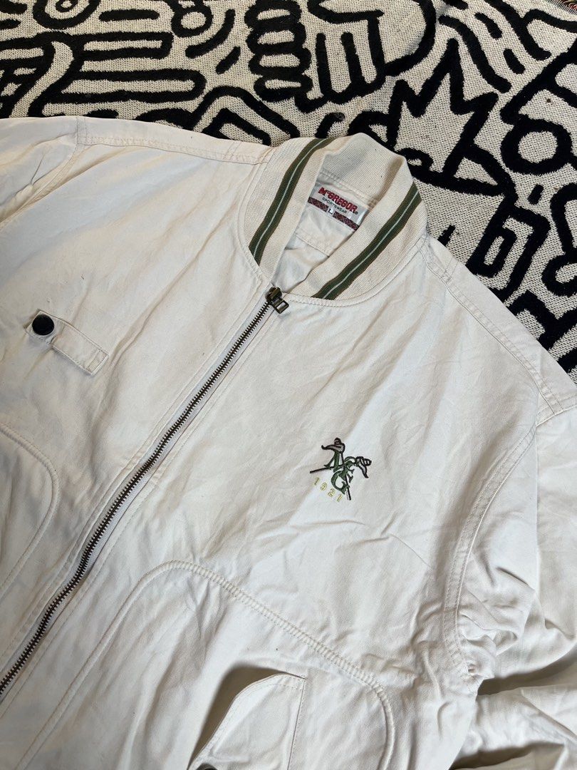 McGregor Sportswear Bomber Jacket - Cream - Size L (Category: Coats, Jackets and Outerwear) located in Silang. Submitted by yusthrift (Listing ID 1449344757, Image 2). Description: - Cream-colored bomber jacket by McGregor Sportswear - Features stylish green striped collar and cuffs - Embroidered logo detail on the front - Two front pockets with secure button closures - Full zip-up front for easy wear - Ideal for a cool, casual look Size: L on ta