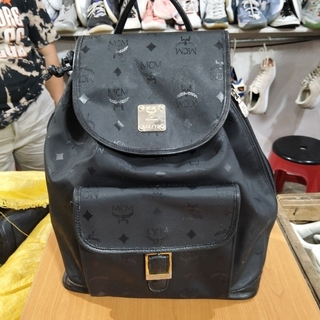 MCM Black Monogram Backpack (Category: Luxury Bags & Wallets) located in El Salvador. Submitted by francheskaukayukay (Listing ID 1449375342, Image 1). Description: - Authentic MCM backpack - All-over signature monogram print - Black leather trim - Gold-tone hardware - Secure drawstring closure with flap top - Convenient front pocket with buckle detail - Adjustable straps for comfortable wear - Interior zippered pocket for essentials - Ideal for 