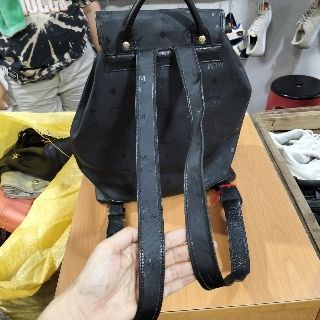 MCM Black Monogram Backpack (Category: Luxury Bags & Wallets) located in El Salvador. Submitted by francheskaukayukay (Listing ID 1449375342, Image 3). Description: - Authentic MCM backpack - All-over signature monogram print - Black leather trim - Gold-tone hardware - Secure drawstring closure with flap top - Convenient front pocket with buckle detail - Adjustable straps for comfortable wear - Interior zippered pocket for essentials - Ideal for 