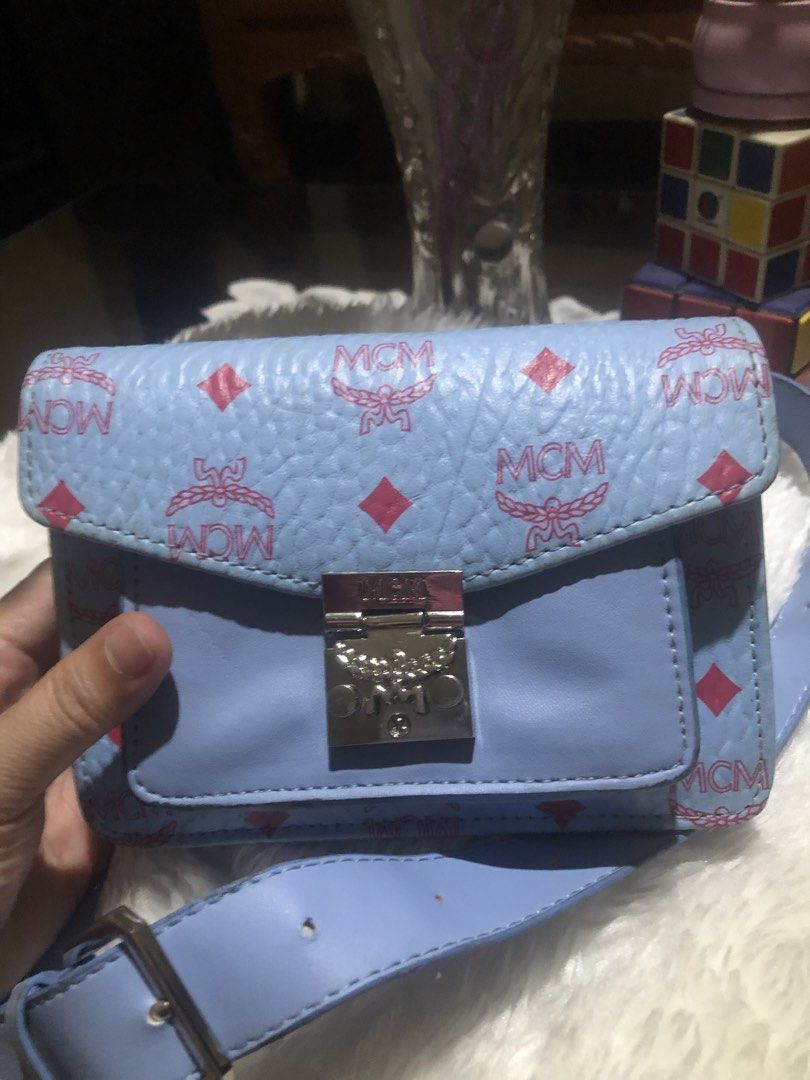MCM Light Blue Monogram Belt Bag (Category: Luxury Bags & Wallets) located in Meycauayan. Submitted by miletteaqu82717 (Listing ID 1449398524, Image 2). Description: - Light blue MCM belt bag - Signature monogram print - Silver-tone clasp closure - Brown interior lining - Adjustable strap for versatile wear - Ideal for carrying essentials.