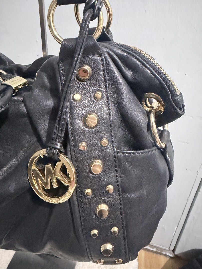 Michael Kors Ludlow Studded Leather Drawstring Shoulder Bag (Category: Luxury Bags & Wallets) located in Manila. Submitted by prelovedbygayle (Listing ID 1449477064, Image 2). Description: Vertical Stud Trim: Ornamented with vertical lines of distinct, highly polished dome-shaped gold studs flanking the front and back panel seams. Cinched Drawstring Design: Configured with a central leather drawstring pull-tab that allows the soft, buttery black 