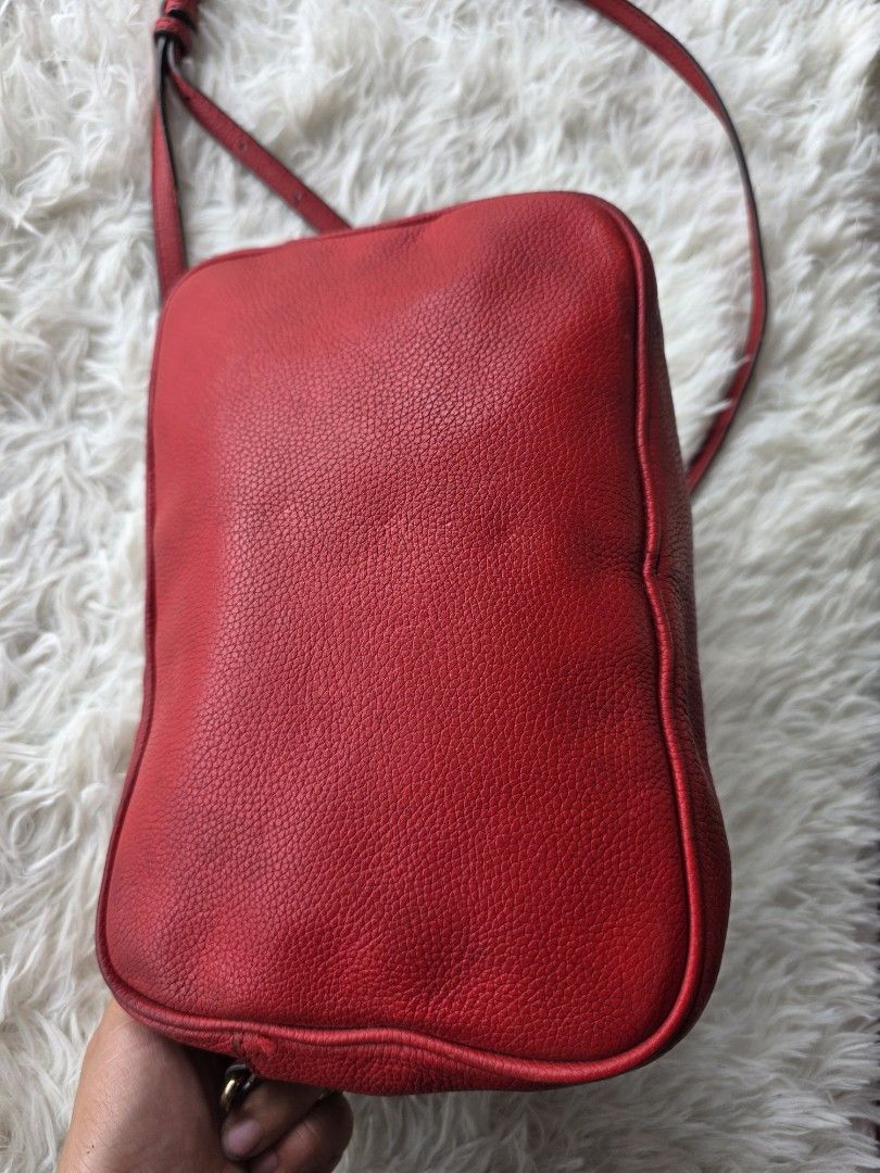Michael Kors Red Leather Crossbody Bag (Category: Cross-body Bags) located in Lemery. Submitted by venus23 (Listing ID 1449343862, Image 3). Description: - Michael Kors red leather crossbody bag - Features iconic gold MK logo on the front - Adjustable strap for comfortable wear - Versatile for daily use or evening events - Shows minor signs of wear on corners and edges, consistent with use - Interior is clean and well-maintained - Plenty of life 