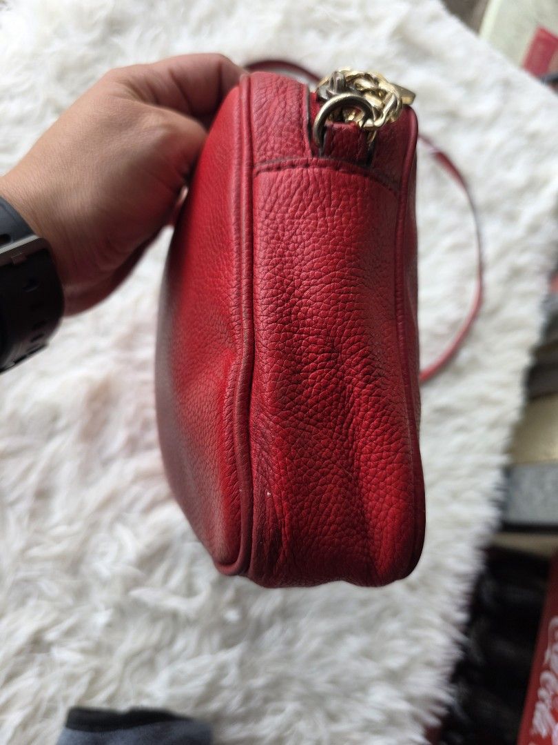 Michael Kors Red Leather Crossbody Bag (Category: Cross-body Bags) located in Lemery. Submitted by venus23 (Listing ID 1449343862, Image 2). Description: - Michael Kors red leather crossbody bag - Features iconic gold MK logo on the front - Adjustable strap for comfortable wear - Versatile for daily use or evening events - Shows minor signs of wear on corners and edges, consistent with use - Interior is clean and well-maintained - Plenty of life 