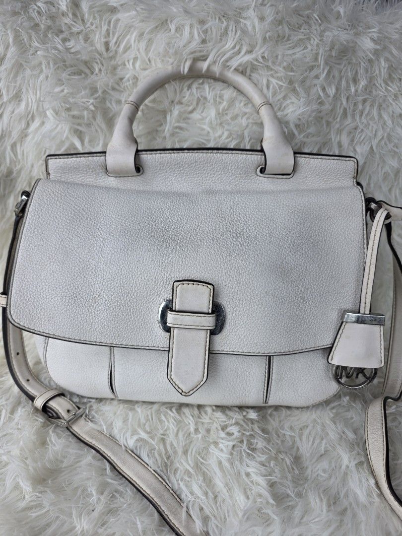 Michael Kors White Leather Satchel Handbag (Category: Luxury Bags & Wallets) located in Lemery. Submitted by venus23 (Listing ID 1449356003, Image 1). Description: - Michael Kors white leather satchel bag - Versatile with top handles and a detachable shoulder strap - Secure front buckle closure - Convenient back zip pocket - Organized interior with multiple pockets and a key clip.