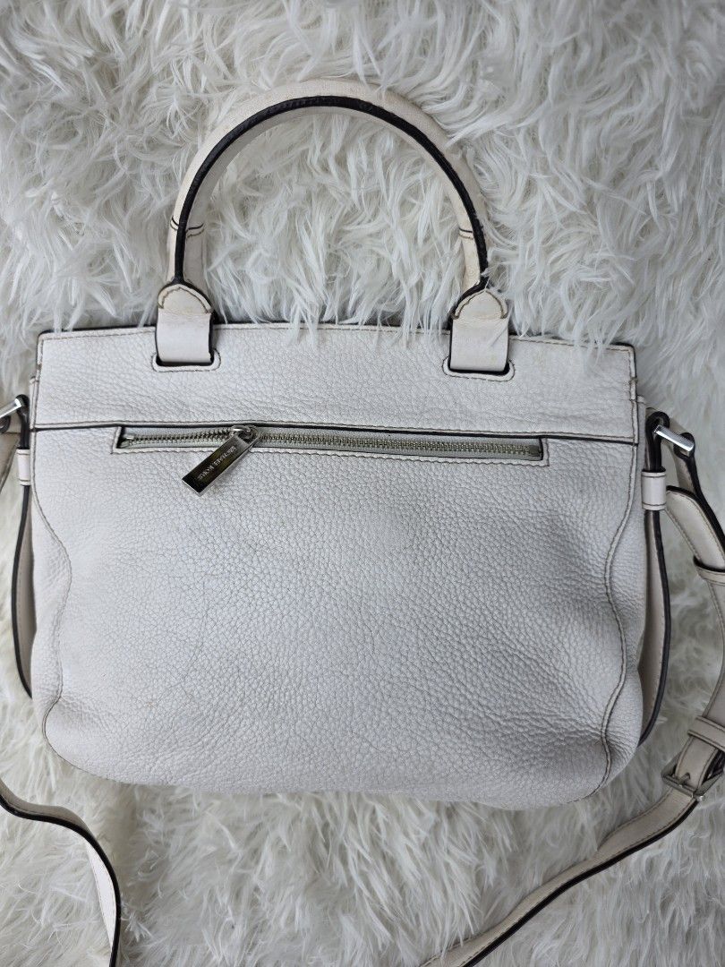 Michael Kors White Leather Satchel Handbag (Category: Luxury Bags & Wallets) located in Lemery. Submitted by venus23 (Listing ID 1449356003, Image 3). Description: - Michael Kors white leather satchel bag - Versatile with top handles and a detachable shoulder strap - Secure front buckle closure - Convenient back zip pocket - Organized interior with multiple pockets and a key clip.