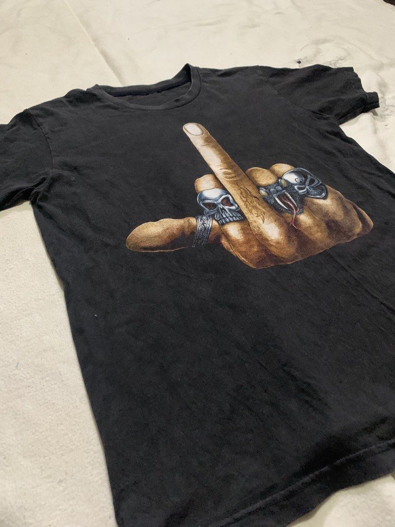 Middle Finger Skull Rings Graphic Print (Category: Tshirts & Polo Shirts ) located in Bulacan. Submitted by solsic (Listing ID 1449506909, Image 2). Description: No tags Pristine Print - Black t-shirt with striking graphic print on front and back. - Features a hand giving the middle finger, detailed with skull and snake rings. W: 19” L: 25” Small to Medium Well used, perfect for casual attire Issue: Mine: 450 plus SF Courier: J&T/Lalamove. Paymen