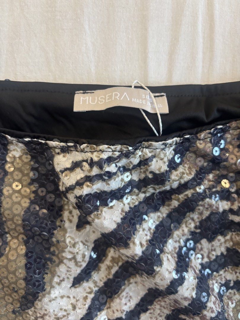 Musera Sequin Zebra Print Mini Skirt with Fringe (Category: Skirts) located in Paranaque City. Submitted by preloved_archives (Listing ID 1449387072, Image 2). Description: Fun sequin mini skirt with a zebra print. Has fringe detailing on the side. Perfect for a night out or a festival look. Brand new with tags still attached. Size S..