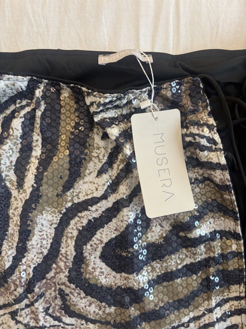 Musera Sequin Zebra Print Mini Skirt with Fringe (Category: Skirts) located in Paranaque City. Submitted by preloved_archives (Listing ID 1449387072, Image 3). Description: Fun sequin mini skirt with a zebra print. Has fringe detailing on the side. Perfect for a night out or a festival look. Brand new with tags still attached. Size S..