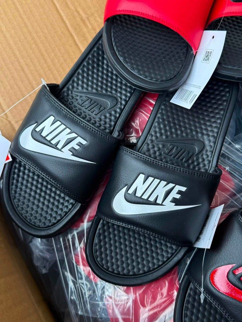 Nike Benassi JDI Slides - Multiple Colors Available (Category: Slippers & Slides) located in Manila. Submitted by gfunkcap (Listing ID 1449478109, Image 3). Description: - Comfortable Nike slides perfect for everyday wear. - Available colors: Black with white swoosh, Black with red swoosh, Red with black swoosh. - Ideal for lounging at home or running quick errands..