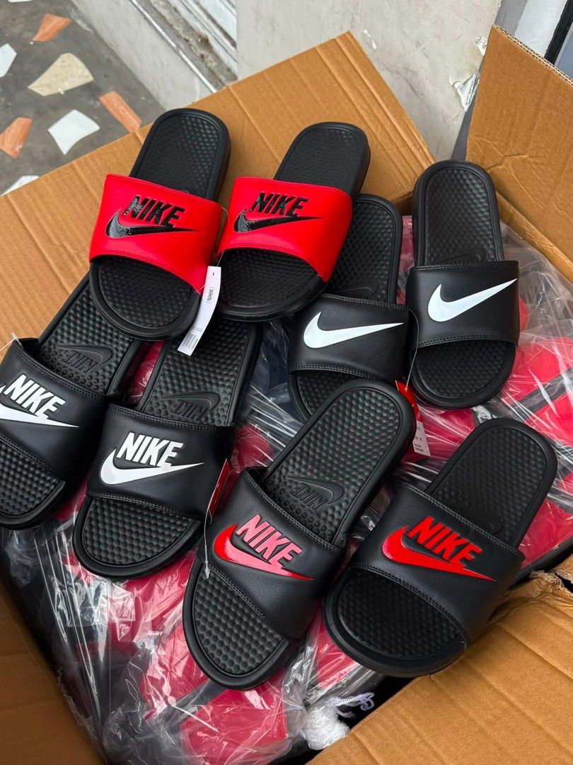 Nike Benassi JDI Slides - Multiple Colors Available (Category: Slippers & Slides) located in Manila. Submitted by gfunkcap (Listing ID 1449478109, Image 1). Description: - Comfortable Nike slides perfect for everyday wear. - Available colors: Black with white swoosh, Black with red swoosh, Red with black swoosh. - Ideal for lounging at home or running quick errands..