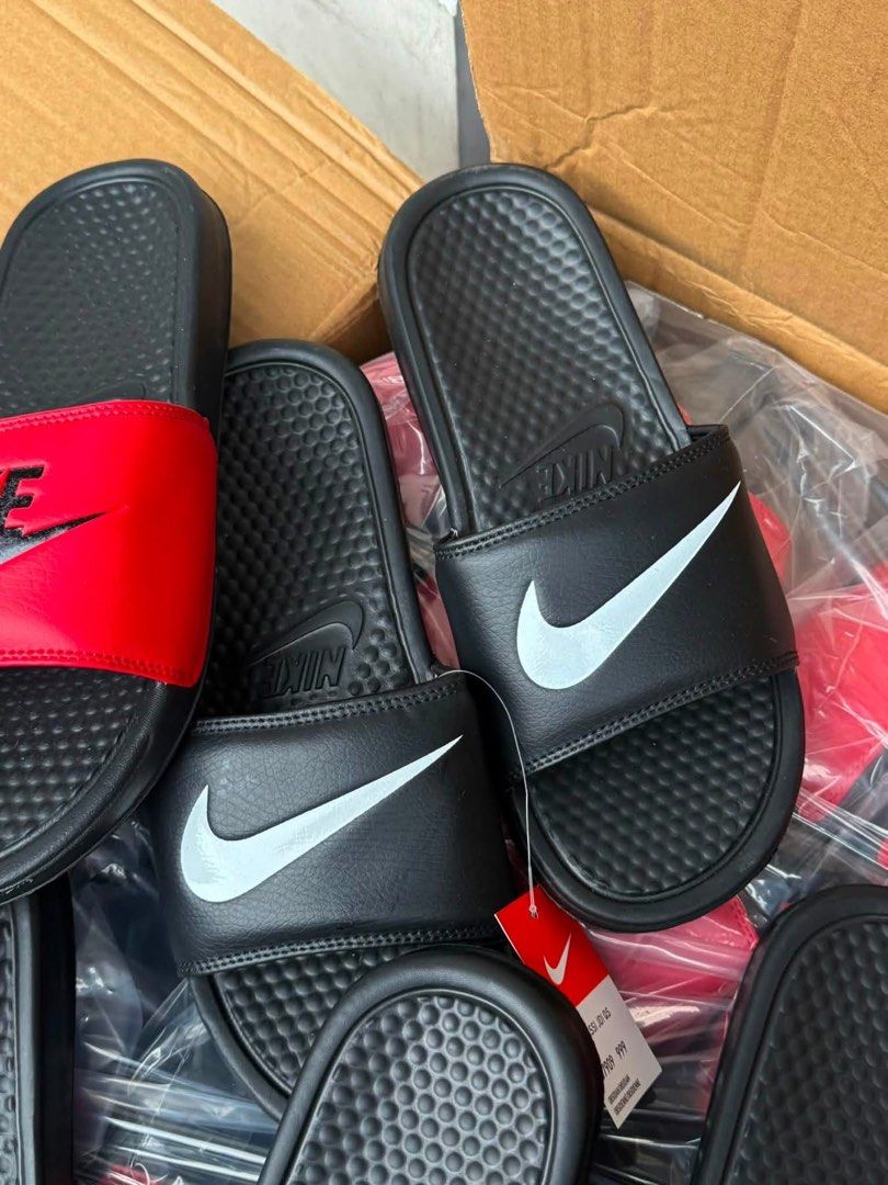 Nike Benassi JDI Slides - Multiple Colors Available (Category: Slippers & Slides) located in Manila. Submitted by gfunkcap (Listing ID 1449478109, Image 2). Description: - Comfortable Nike slides perfect for everyday wear. - Available colors: Black with white swoosh, Black with red swoosh, Red with black swoosh. - Ideal for lounging at home or running quick errands..