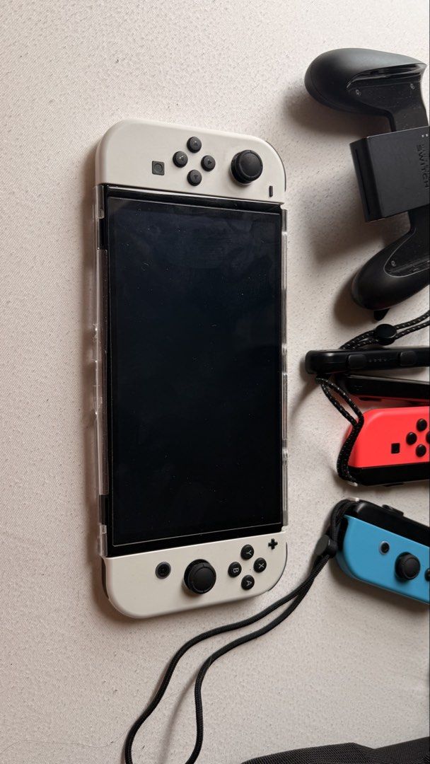 Nintendo Switch OLED 64 gb (Category: Nintendo) located in Makati City. Submitted by mdcb___ (Listing ID 1449394609, Image 2). Description: Gifted. Barely used. Maybe only 2 weeks. Good as new. Not jailbroken. Complete and original accessories. 13,500, fixed price. Inclusions: 1 - Nintendo Switch™ console (OLED model)* (HEG-001) 2 - Joy-Con™ (L) (HAC-015) 3 - Joy-Con (R) (HAC-016) 4 - Joy-Con Straps (HAC-014) 5 - High Speed HDMI™ Cable (HEG-005) 