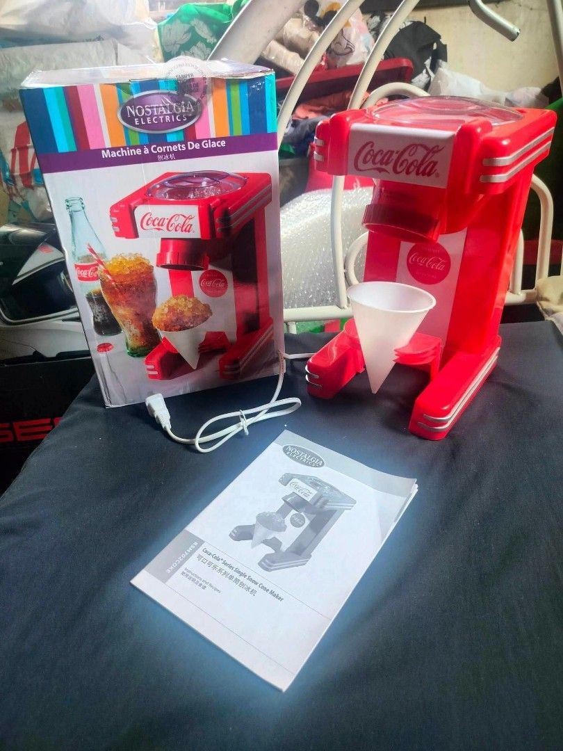 Nostalgia Coca-Cola Ice Cream Cone Maker Machine (Category: Other Kitchen Appliances) located in Marilao. Submitted by shanelle_nicola (Listing ID 1449463732, Image 1). Description: - Fun Coca-Cola themed ice cream cone maker - Makes delicious shaved ice treats - Comes with original box and instruction manual - Easy to use and clean - Perfect for parties or a sweet treat at home.