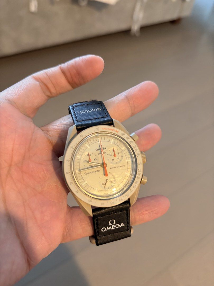 Omega x Swatch Speedmaster Moonswatch (Category: Luxury Watches) located in Quezon City. Submitted by hendrix2 (Listing ID 1436286512, Image 2). Description: - Omega x Swatch Speedmaster Moonswatch - Beige dial - Chronograph subdials - Tachymeter scale - Black strap with Omega branding - Swatch logo on strap and face - Speedmaster and Moonswatch text on dial.
