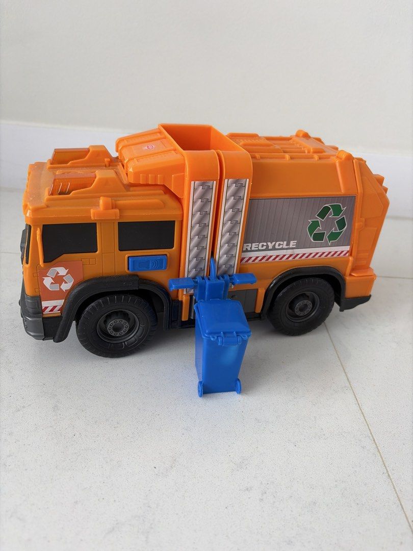Orange Recycle Garbage Truck Toy with Blue Bin (Category: Toys & Games) located in Kuala Lumpur. Submitted by darianik (Listing ID 1449373348, Image 1). Description: - Fun orange garbage truck toy - Includes a little blue trash bin - Encourages imaginative play - Features recycle symbols on the side - Great for teaching kids about recycling.