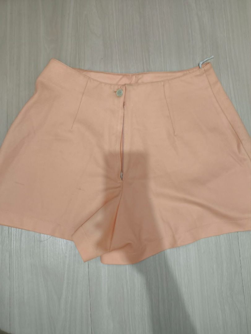 Peach Skort with Buckle Detail (Category: Shorts) located in Manila. Submitted by weyt_k (Listing ID 1449506289, Image 2). Description: - Adorable peach skort - Features a decorative buckle on the side - Front zipper and button closure for easy wear - Stylish skirt appearance with built-in shorts for added comfort and coverage - Ideal for casual outings and everyday wear.