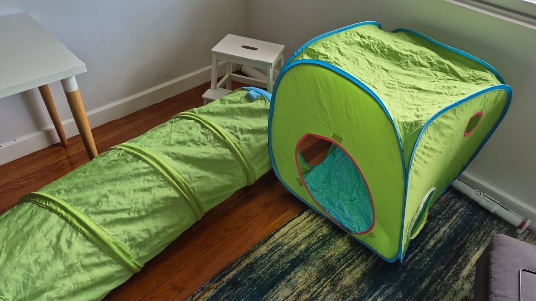 Play tent and tunnel (Category: Infant Playtime) located in Muntinlupa City. Submitted by trish987 (Listing ID 1449496697, Image 2). Description: - Play tent and tunnel set for children's entertainment. - Vibrant green color with blue and pink accents. - Includes a cube-shaped tent with windows and a long crawling tunnel. - Made from durable fabric for long-lasting fun. - Simple to set up and fold for convenient storage. - Ideal for encouraging i