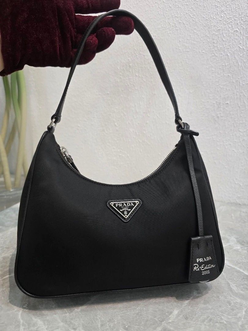 Prada Re-Edition 2005 Mini Shoulder Bag (Category: Luxury Bags & Wallets) located in Manila. Submitted by ej.collections (Listing ID 1449327475, Image 2). Description: NEGOTIABLE PRICE ALL ITEMS ARE ONHAND 💯 GUARANTEED AUTHENTIC MONEY BACK IF PROVEN FAKE •Size: Mini •Condition: In excellent condition/Rank A •Inclusions: Bag & dustbag •Plus shipping fee •Local & international shipment 📍Loc. Davao City.