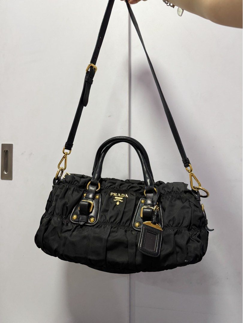 Prada Ruched Tessuto Nylon Shoulder Bag Black (Category: Luxury Bags & Wallets) located in Manila. Submitted by tinseyra (Listing ID 1449368889, Image 1). Description: - Authentic Black Prada Ruched Tessuto Nylon Bag - Elegant Leather Handles and Trim - Classic Gold Hardware - Includes Detachable Shoulder Strap - Comes with Original Leather Luggage Tag - Spacious Interior for Everyday Essentials - Versatile and Stylish for Daily Use.