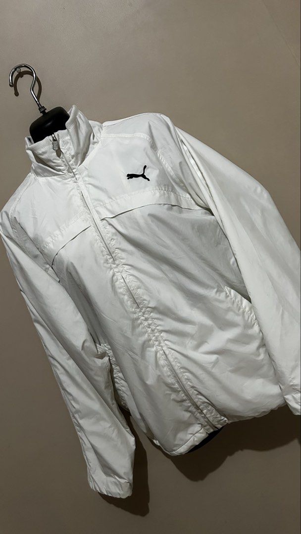 Puma White Track Jacket (Category: Coats, Jackets and Outerwear) located in Baliuag. Submitted by declutterbynadz (Listing ID 1448150129, Image 2). Description: - White Puma track jacket - Zip-up front with stand-up collar - Two front pockets - Puma logo on chest - Stripes on sleeves - Ideal for casual wear or sports .