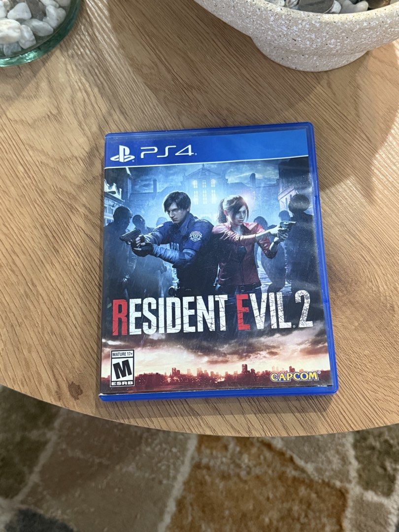 Resident Evil 2 Remake PS4 Game (Category: PlayStation) located in Manila. Submitted by banana09_ (Listing ID 1449399813, Image 1). Description: - Resident Evil 2 Remake for PlayStation 4 - Experience the classic survival horror reimagined - Play as Leon S. Kennedy or Claire Redfield - Survive the zombie outbreak in Raccoon City - Features intense action and terrifying scares - Rated M for Mature.